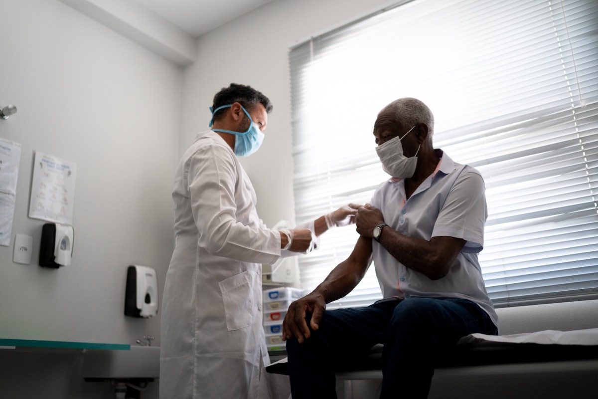 Nurse applying vaccine on patient's arm