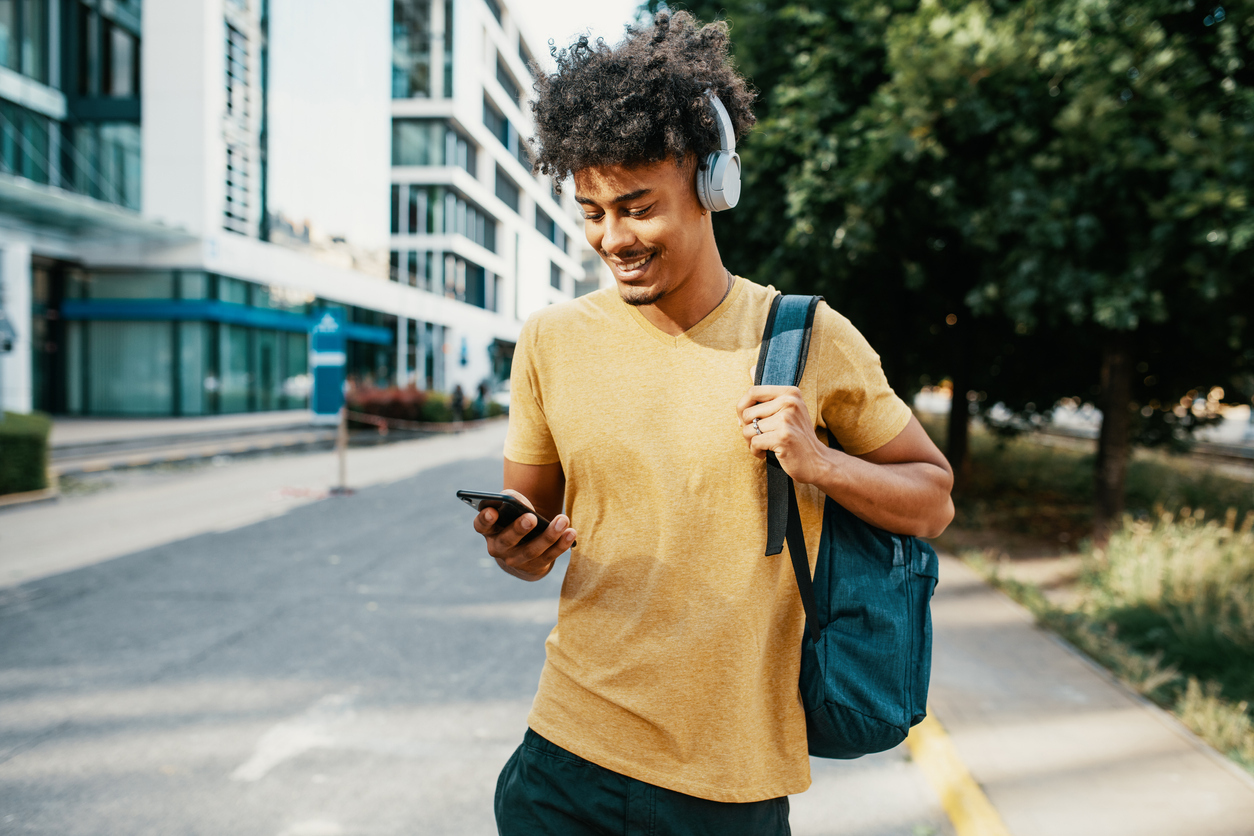 young black man enjoying music in the summer