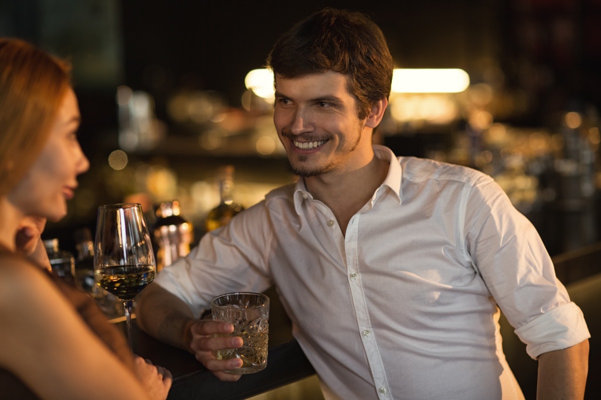 Man approaching woman at a bar