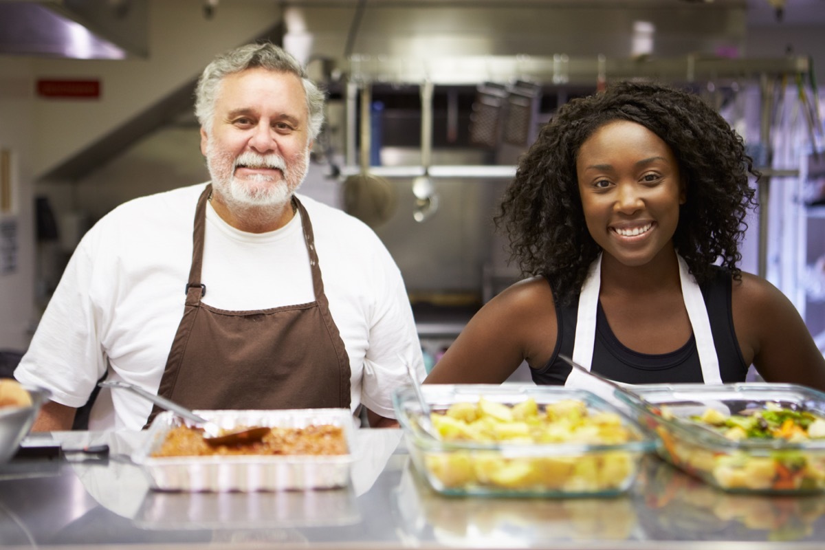 Man and Woman Volunteering at a Soup Kitchen How to Make Friends as an Adult