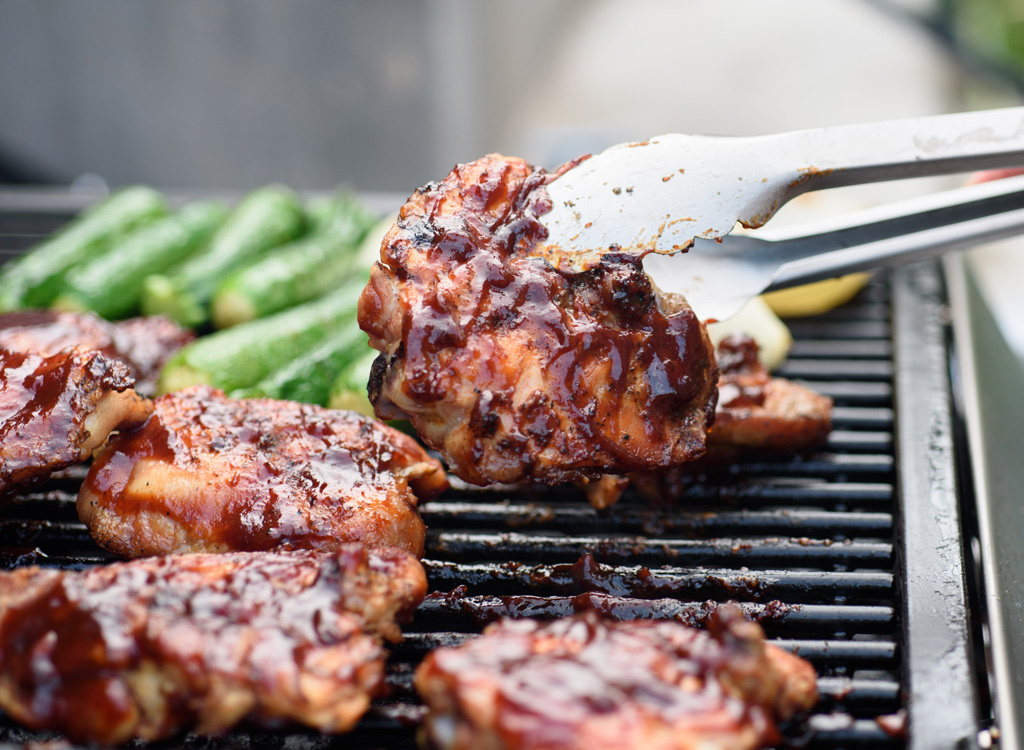 Flipping chicken on grill