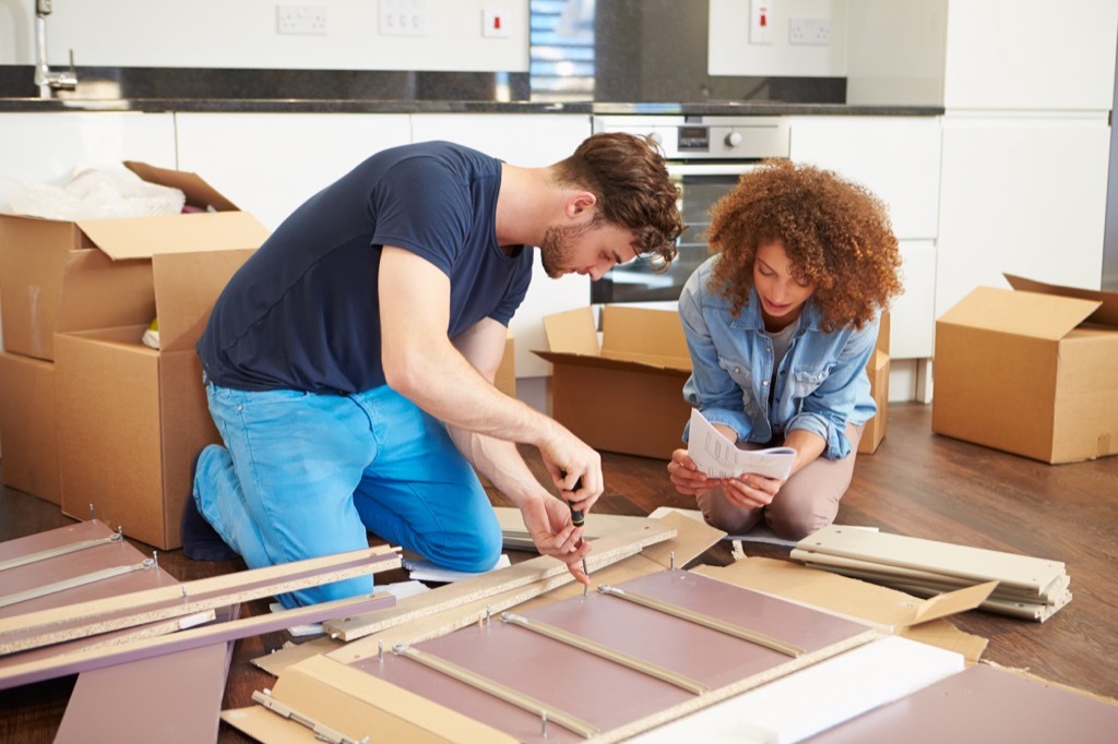 Man and a woman building furniture together.