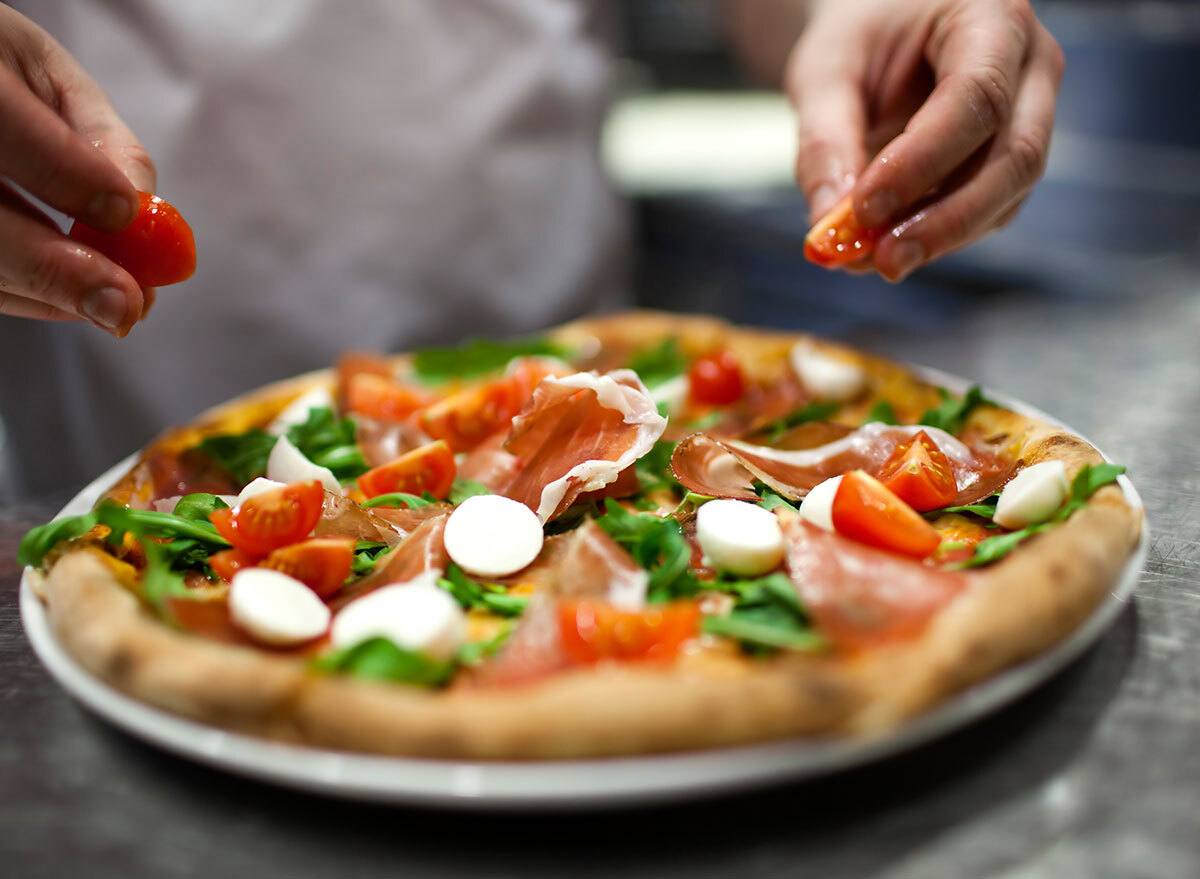 pizza adding tomatoes