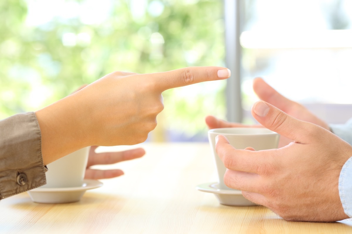 close up of the hands of a couple arguing with woman pointing finger at man, etiquette mistakes