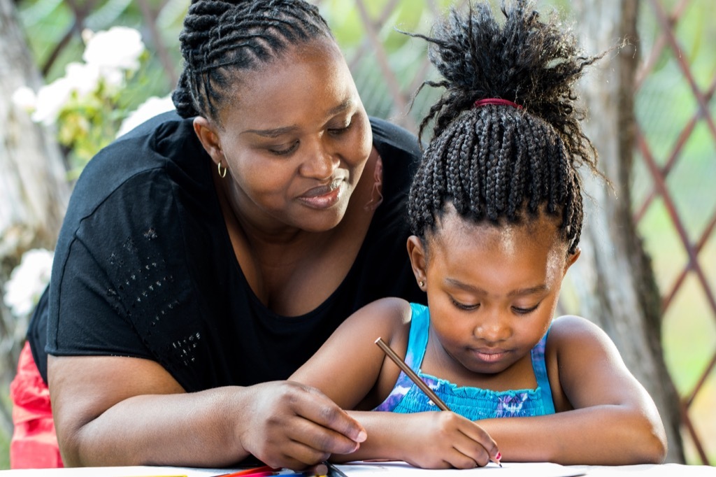 mother helping daughter with homework