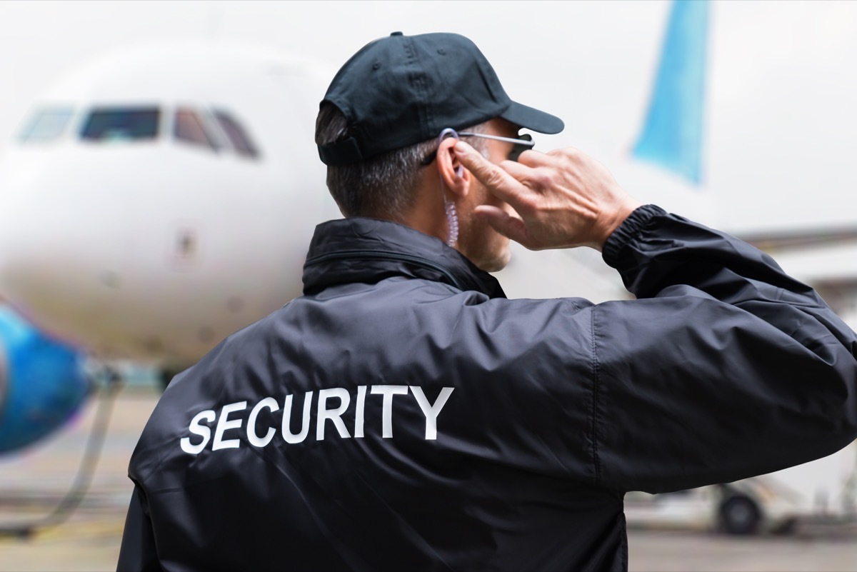 security personnel on the ground near an airplane