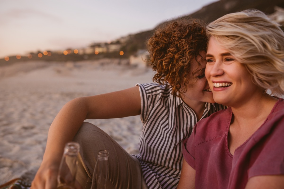 affectionate lesbian couple on beach