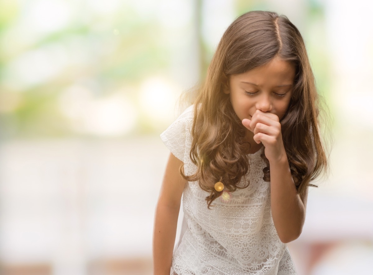 girl feeling unwell and coughing