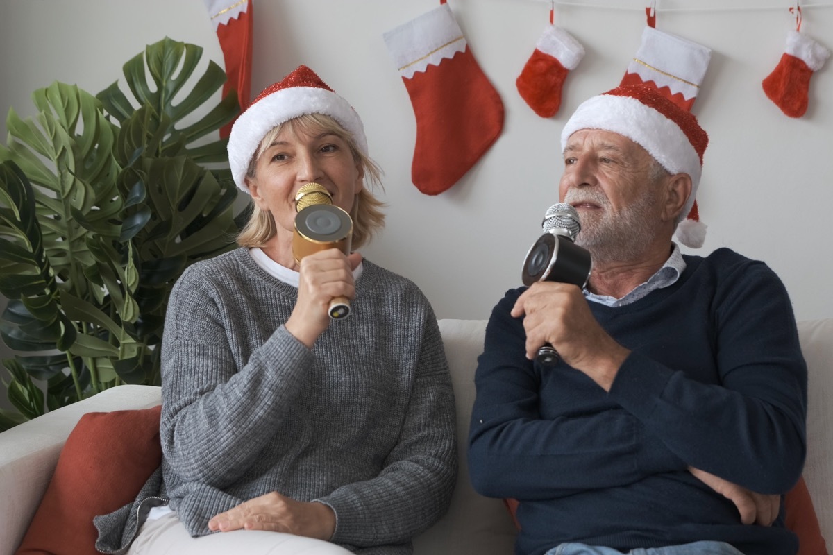 two older people singing christmas karaoke