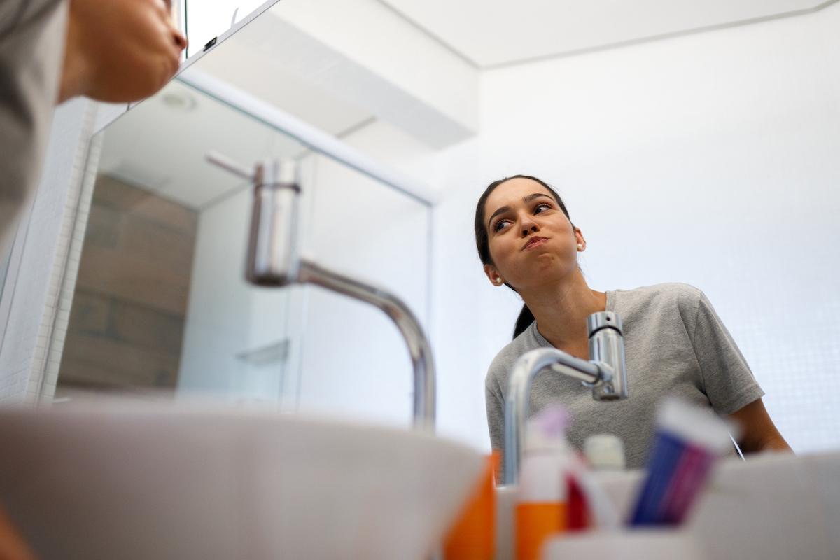 Girl doing her mouth hygiene in the morning.