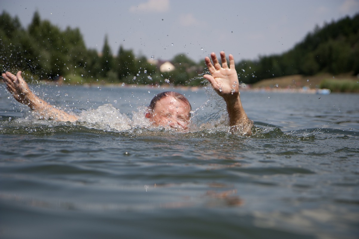 Drowning swimmer at a lake in summer