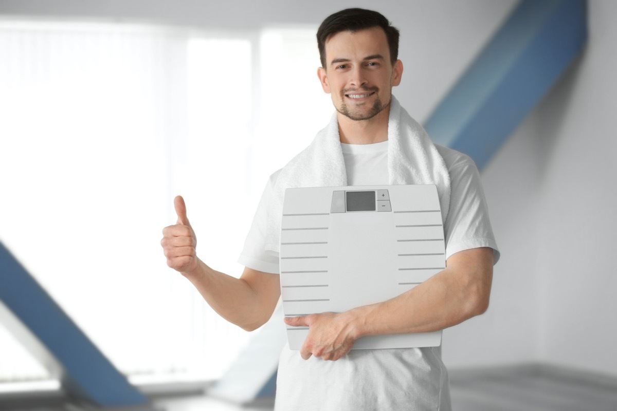 Man holding weight scale