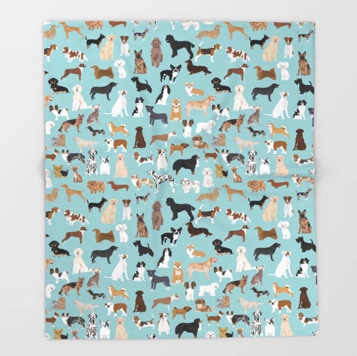 A blue throw blanket with dogs all over it