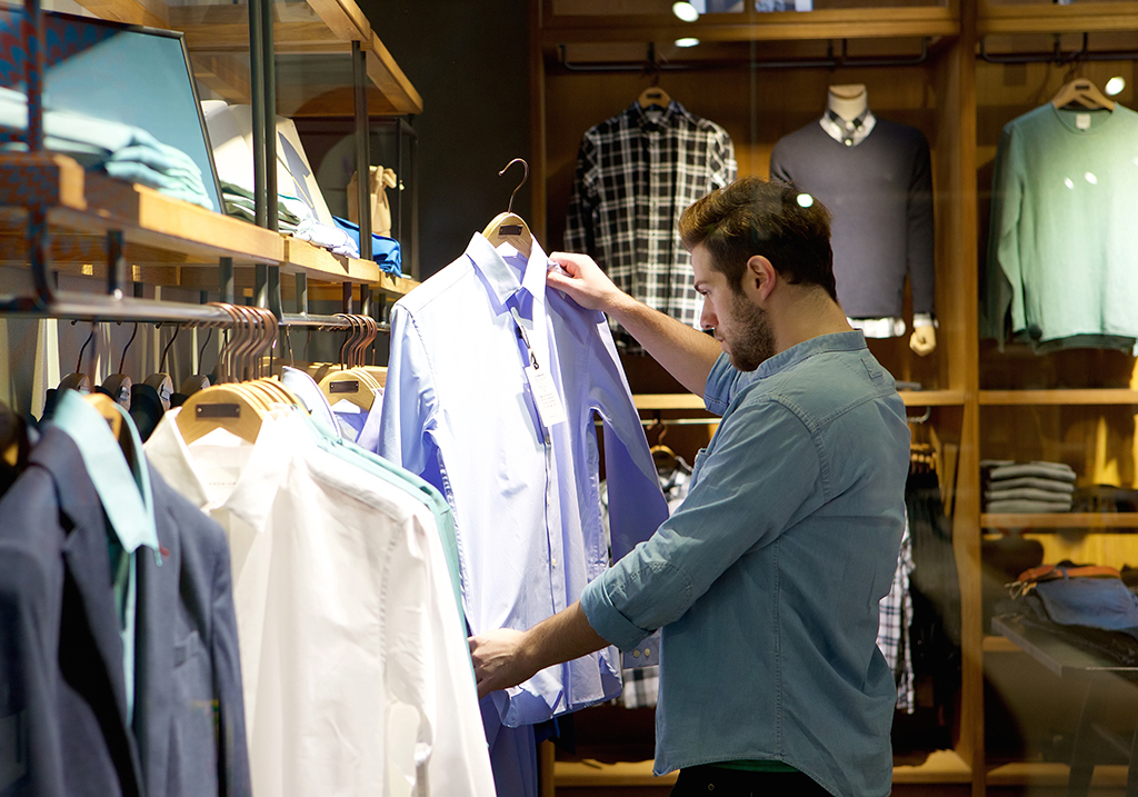 man looking at clothes, shirts, still single, shopping