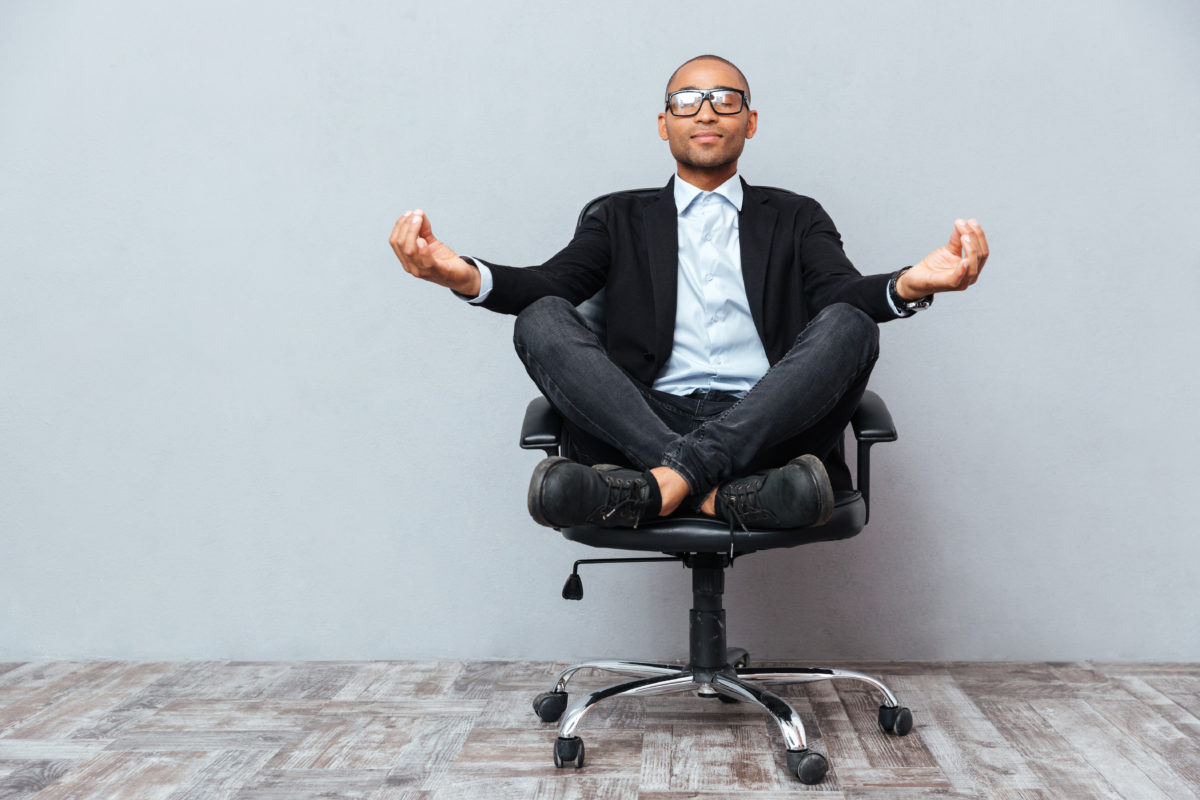 Man Meditating in Office