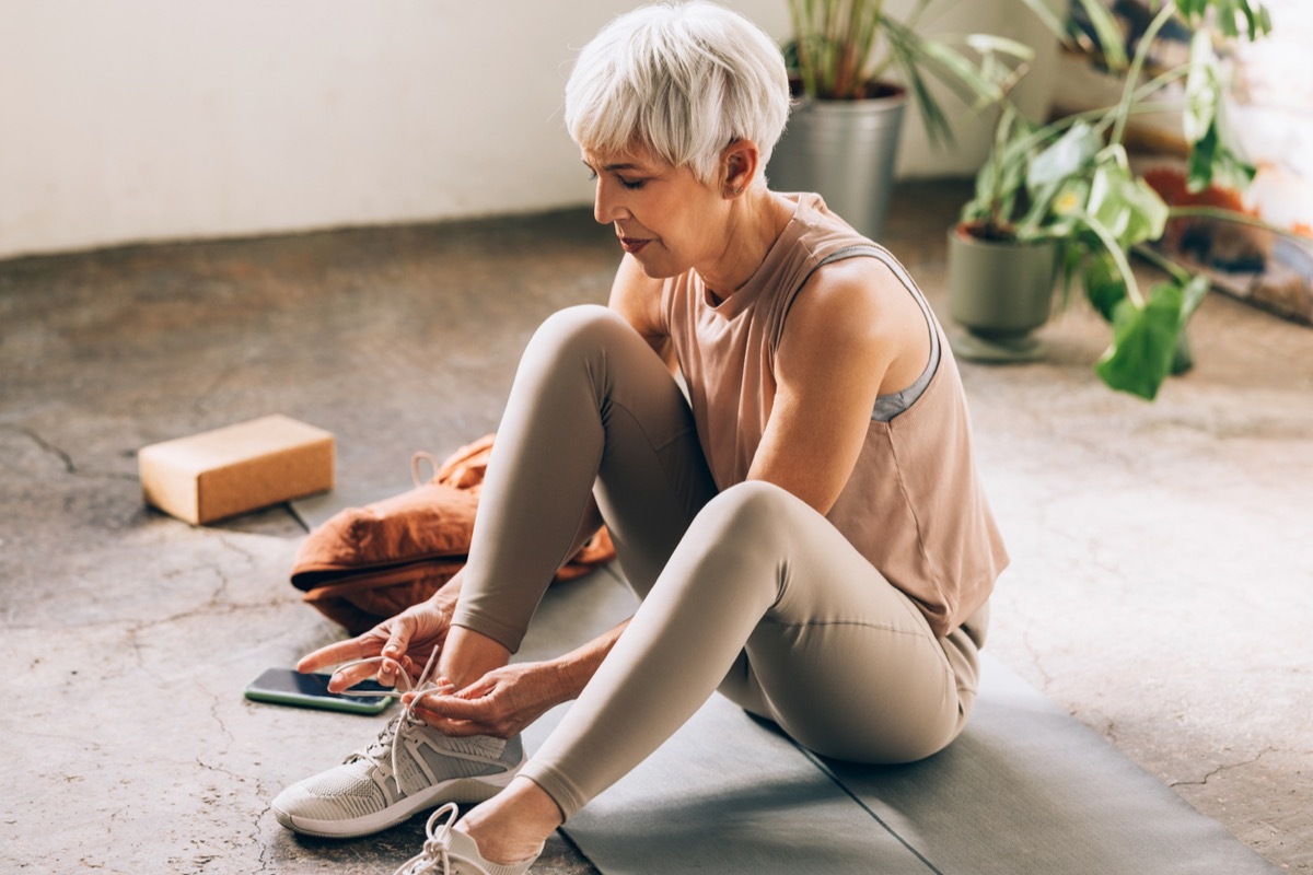 older woman tying sneakers