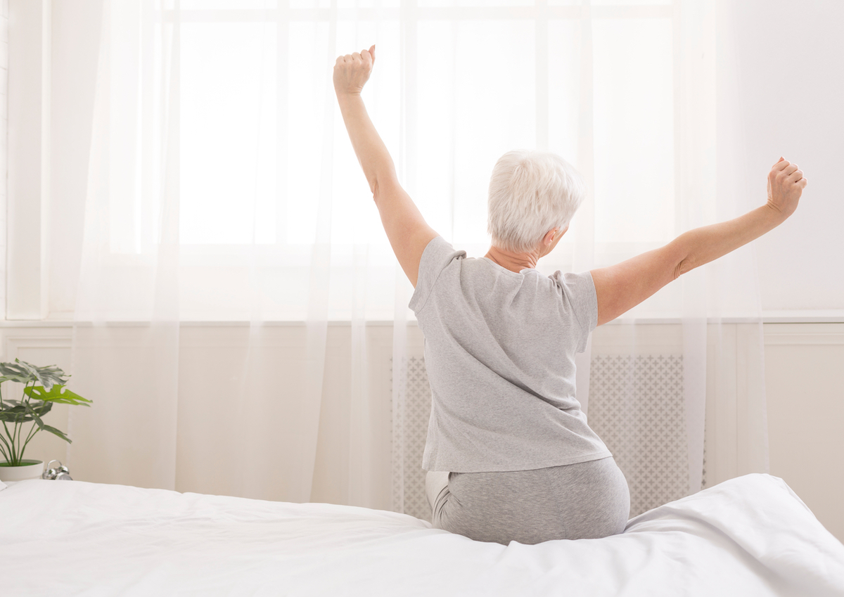 Older woman waking up refreshed