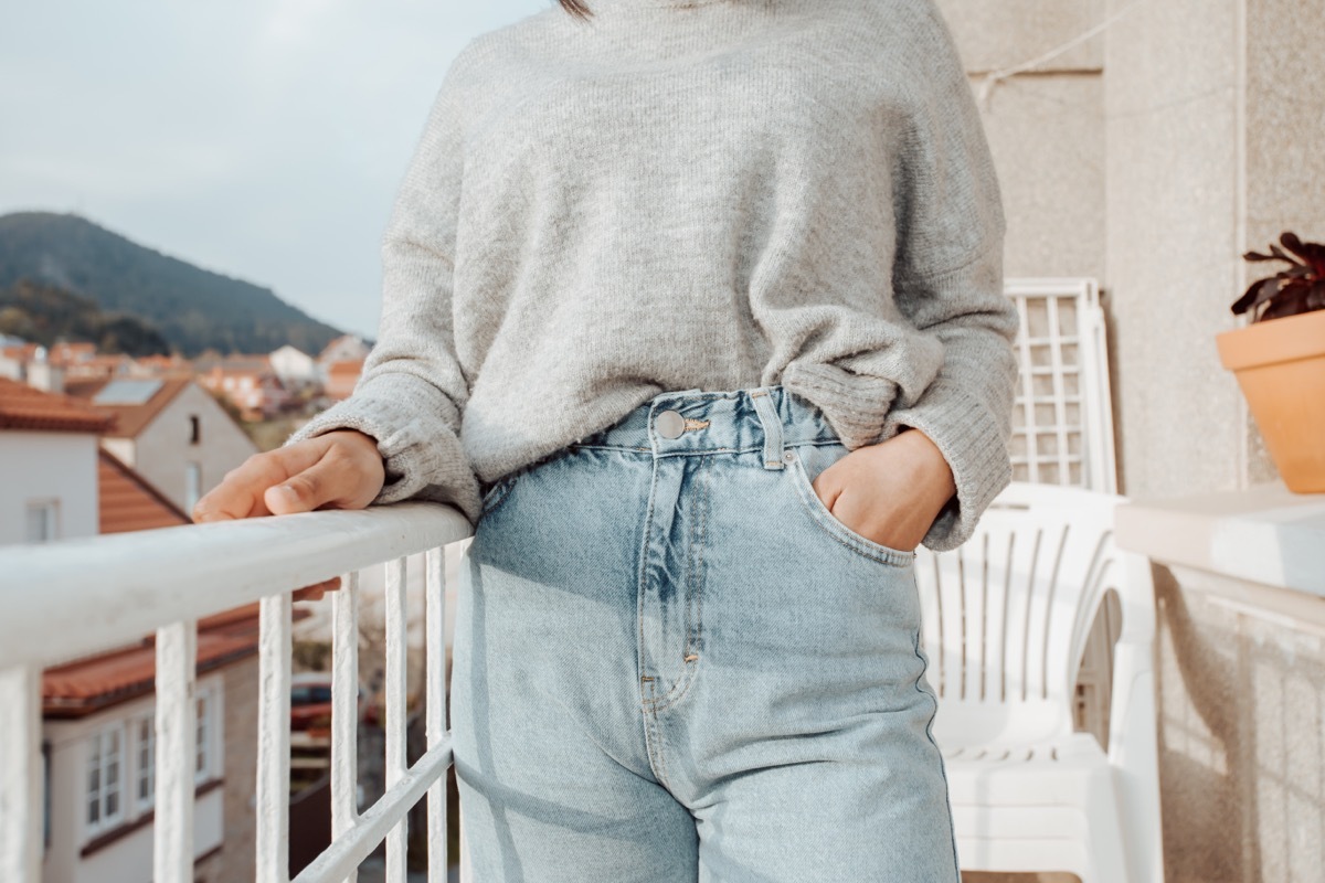 Close up of a woman wearing mom jeans with copy space during a bright day, fashion and styling concept