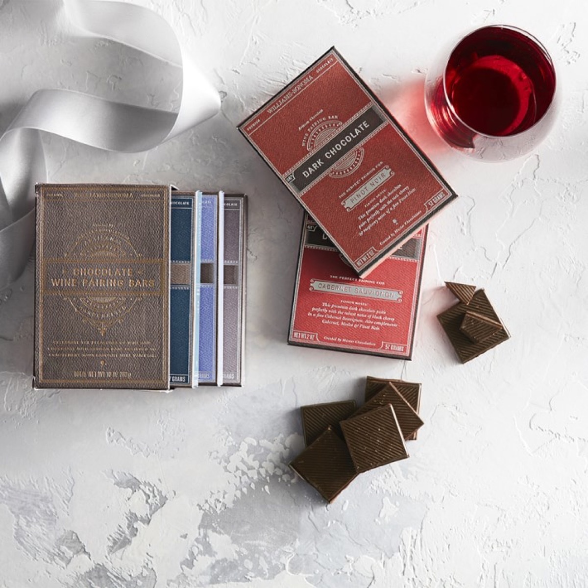 glasses of wine and pieces of chocolate on kitchen counter