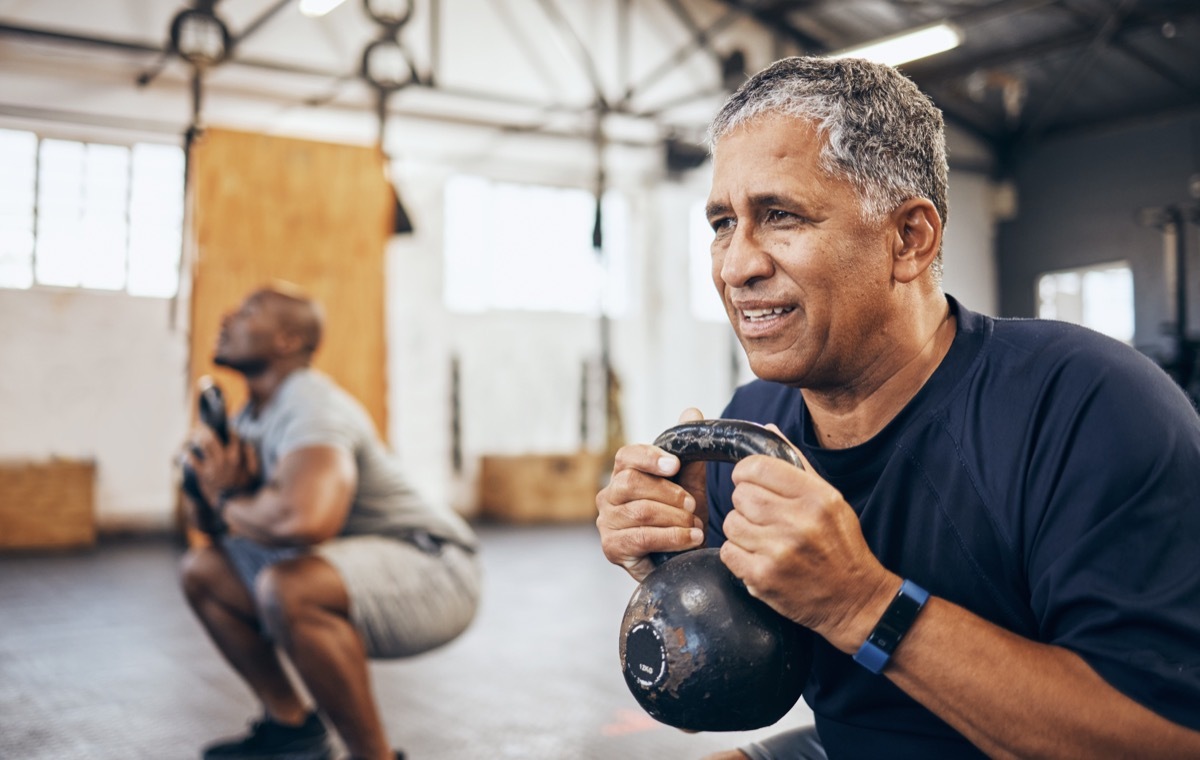 two men using kettlebells strength training