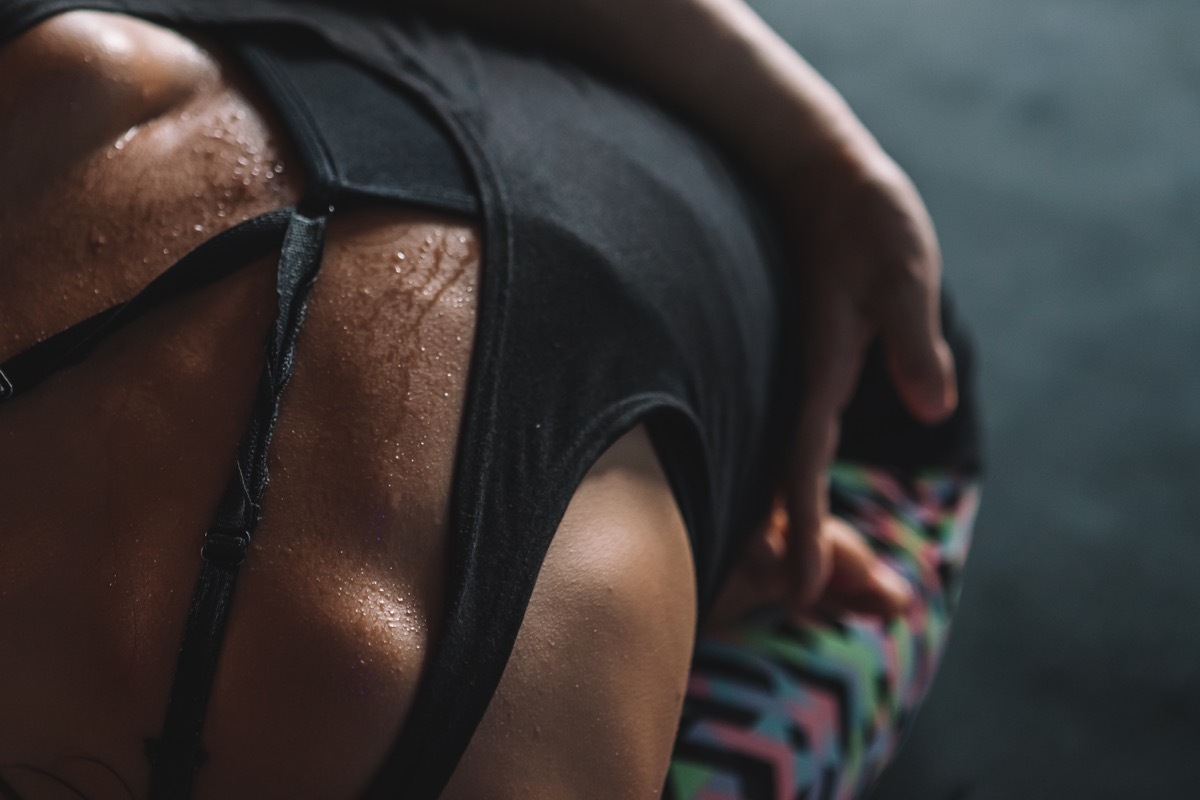 Young lady sweating indoor during her yoga retreat practice