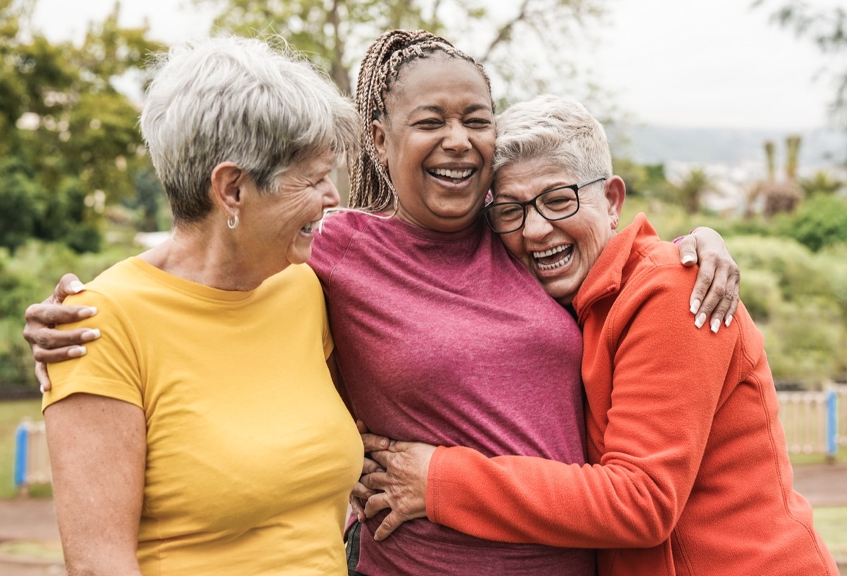 group of friends hugging and laughing