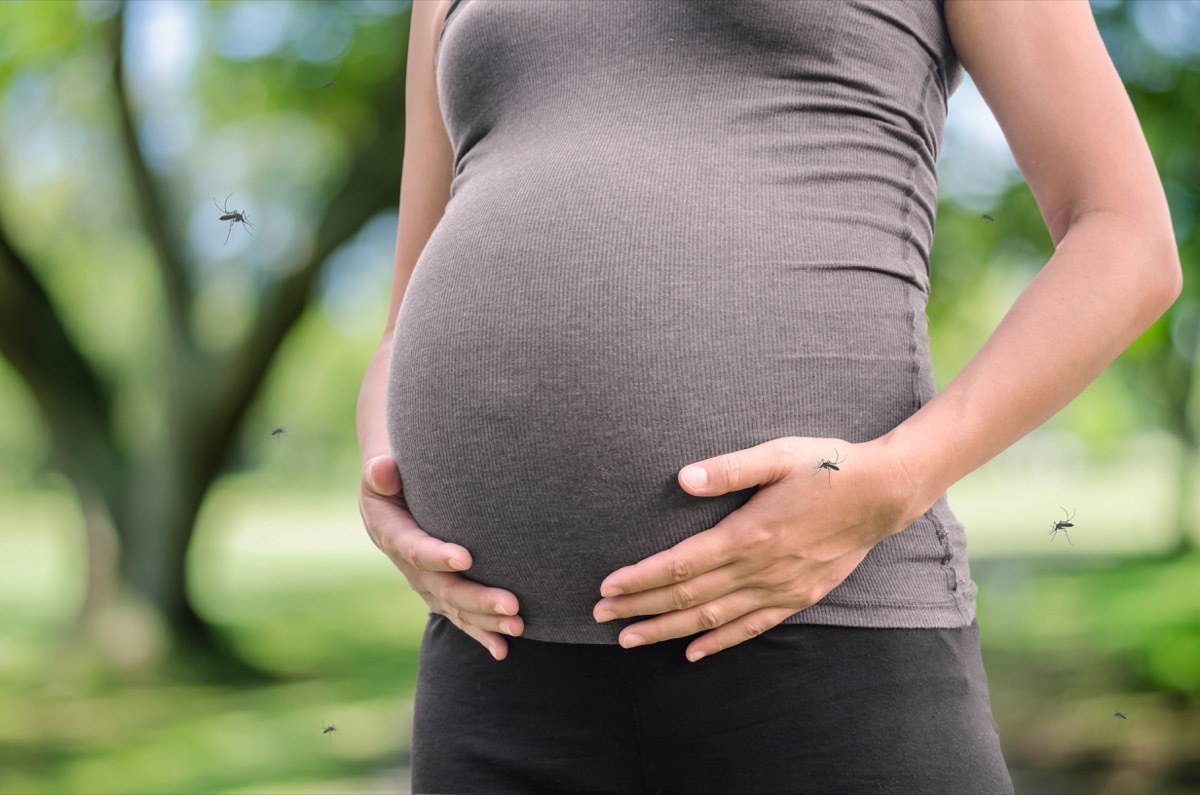 pregnant woman surrounded by mosquitoes