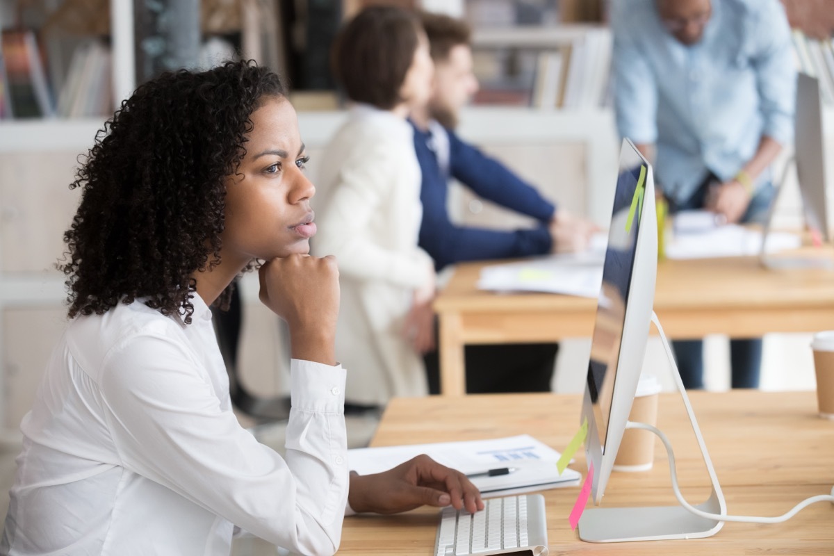 Young Black Woman Thinking at Work