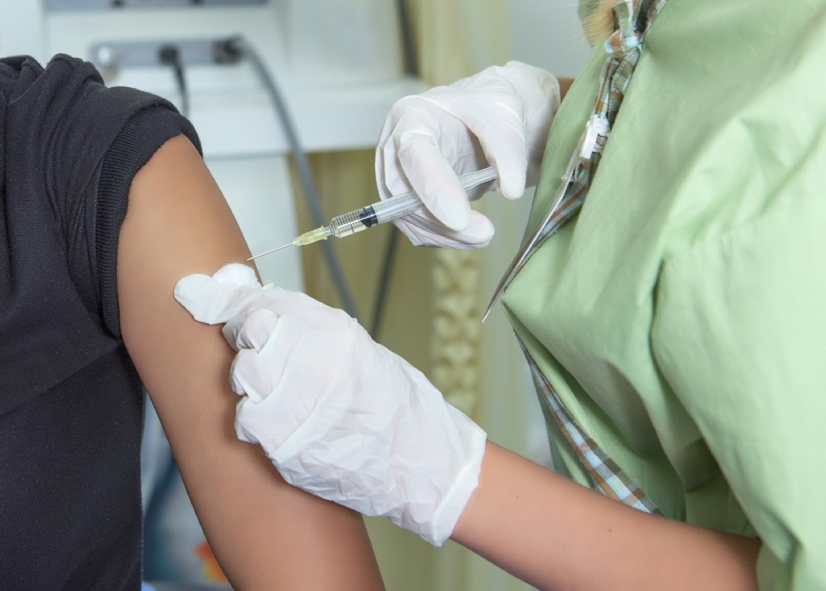 close up of doctor injecting needle into patient's arm