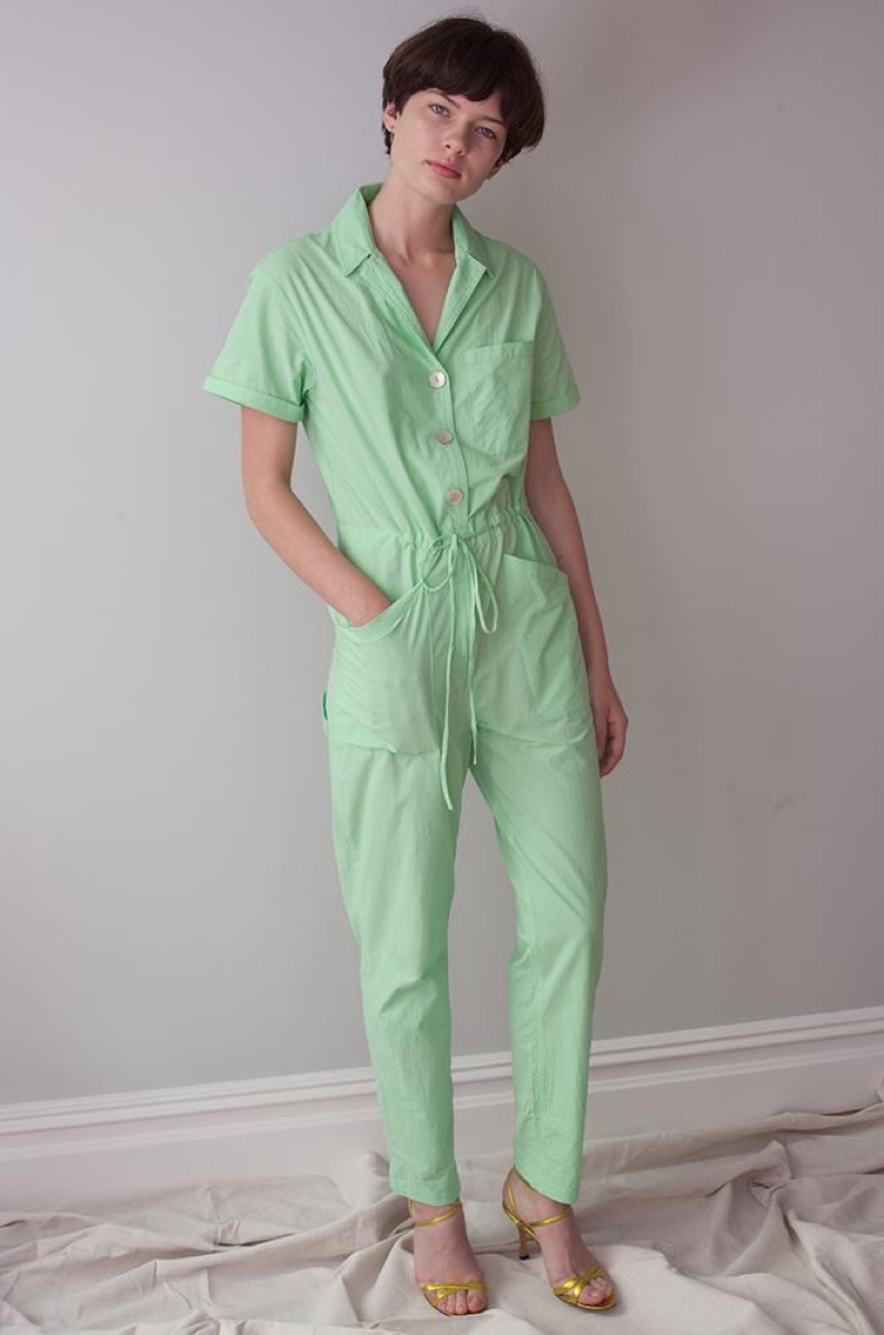 white woman wearing green jumpsuit