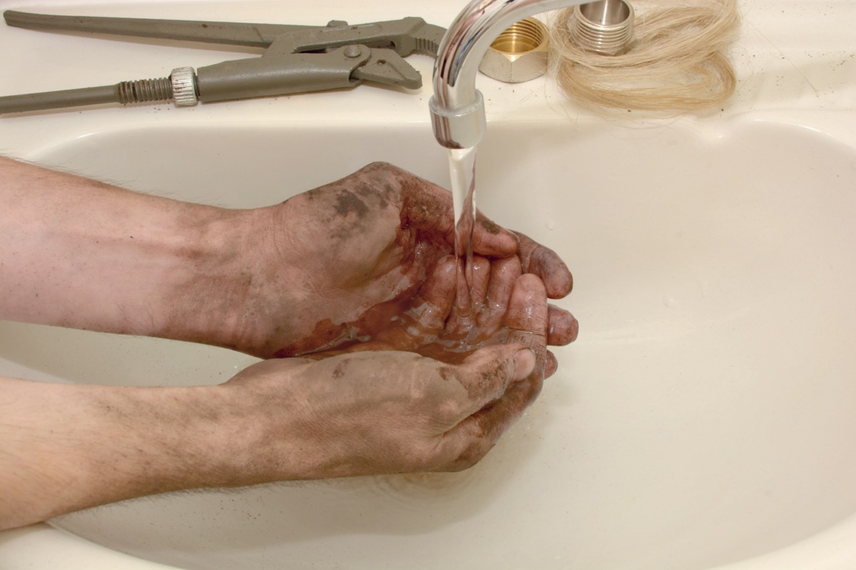 Washing dirty hands in sink