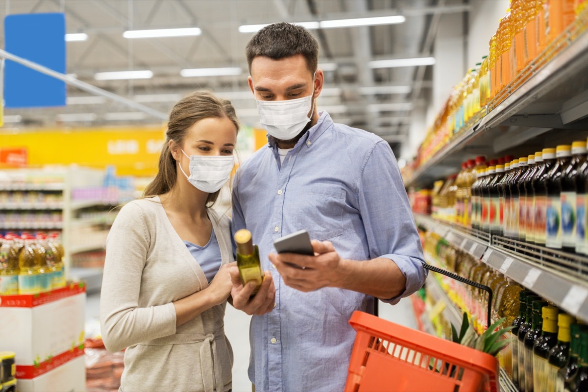 couple checking food label at the store