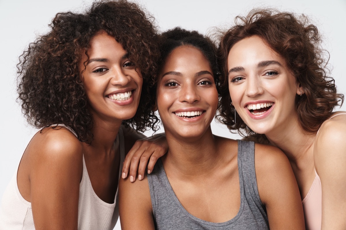 Portrait of three young women smiling