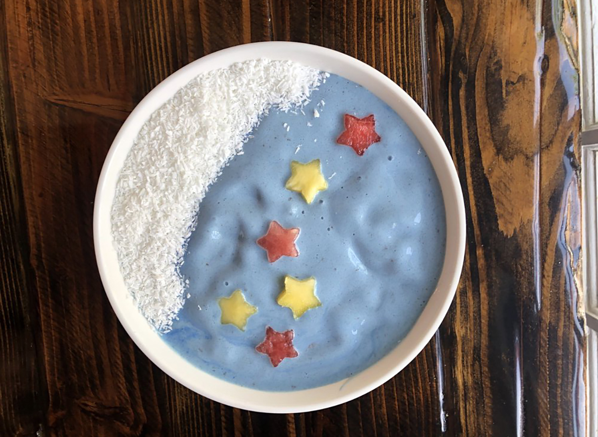 smoothie bowl topped with star-cut fruit and coconut flakes