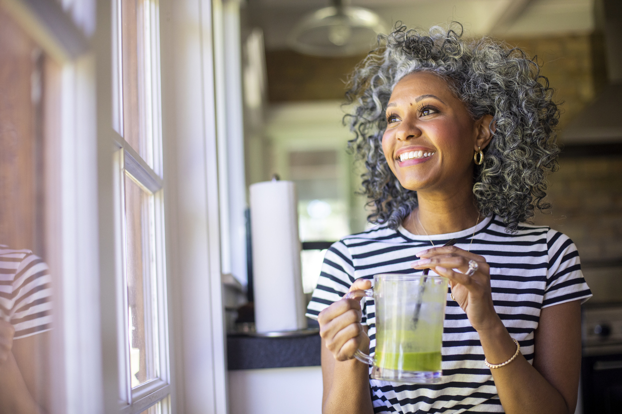 Woman drinking green smoothie. 