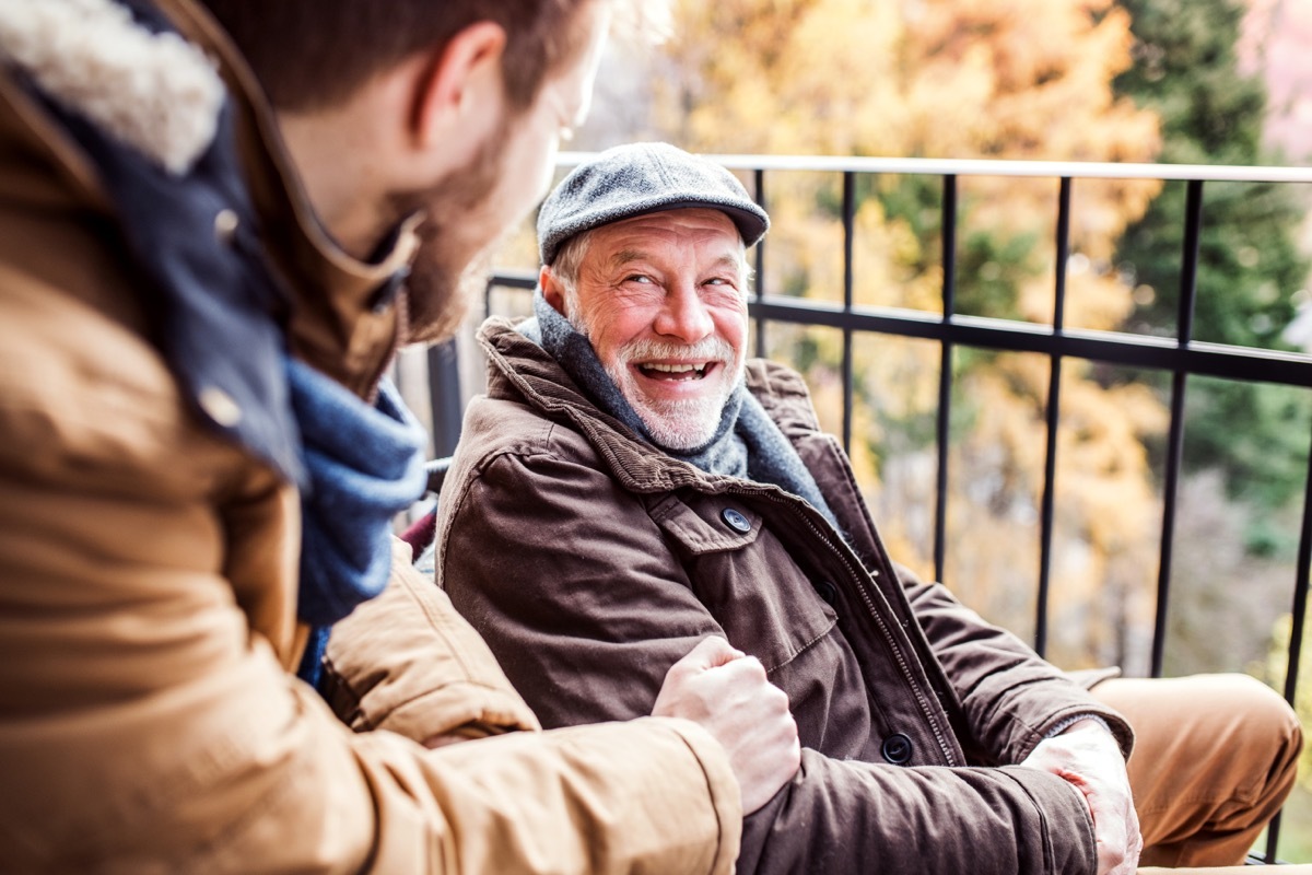 father and son laughing in conversation