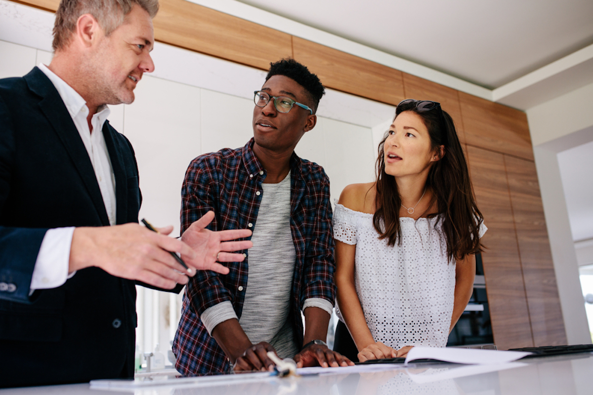 couple having consultation with a real estate agent inside a new home