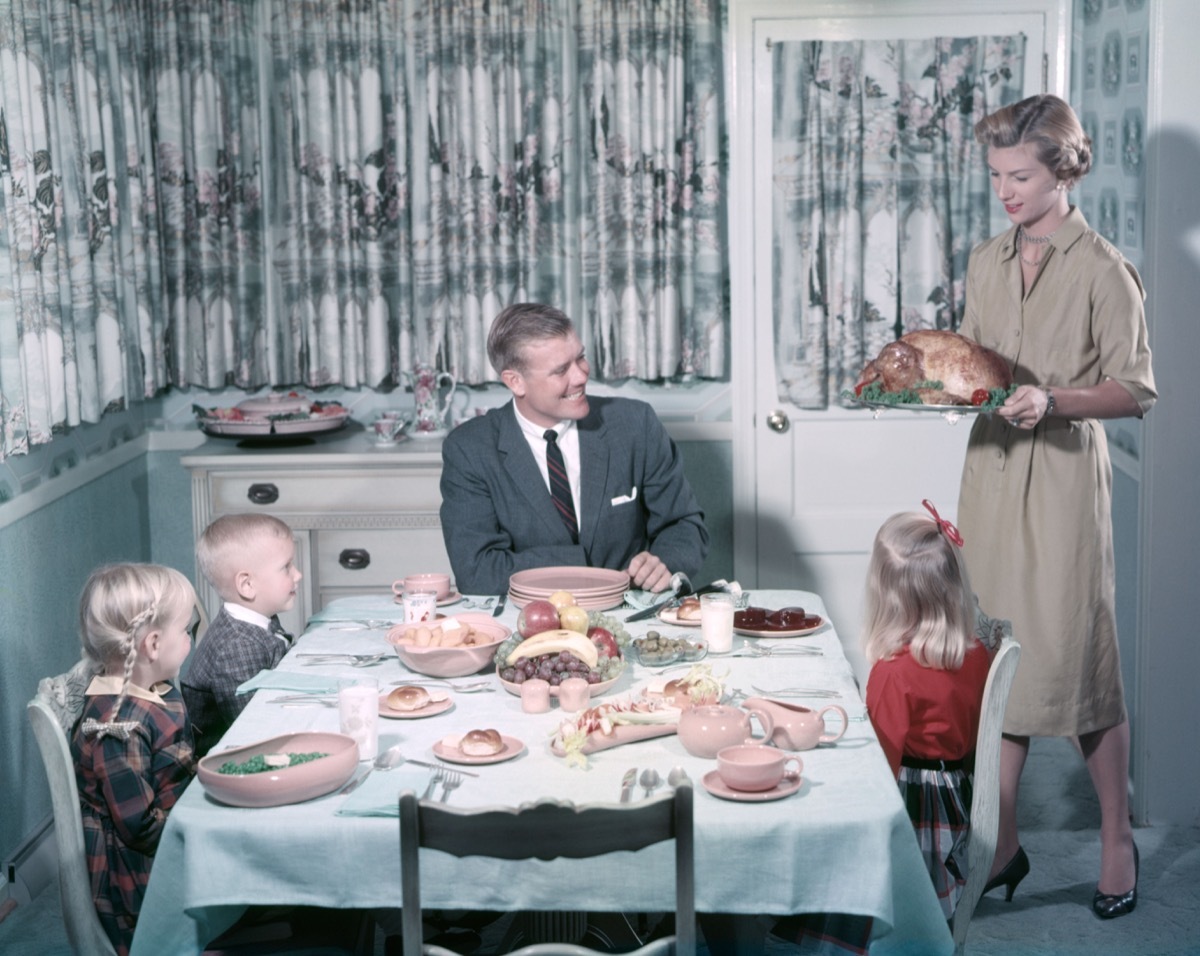 1950s family eats dinner at table, shows how different parenting was 50 years ago