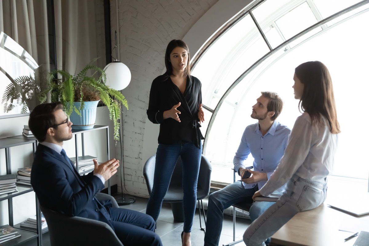 Young Woman Talking to Three Other People