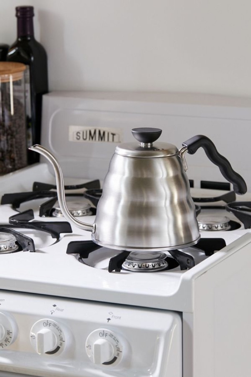 silver kettle sitting on top of gas range