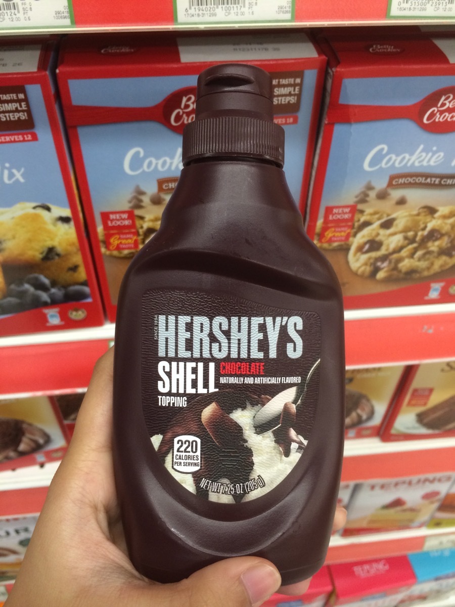 hand holding bottle of hershey's chocolate shell topping