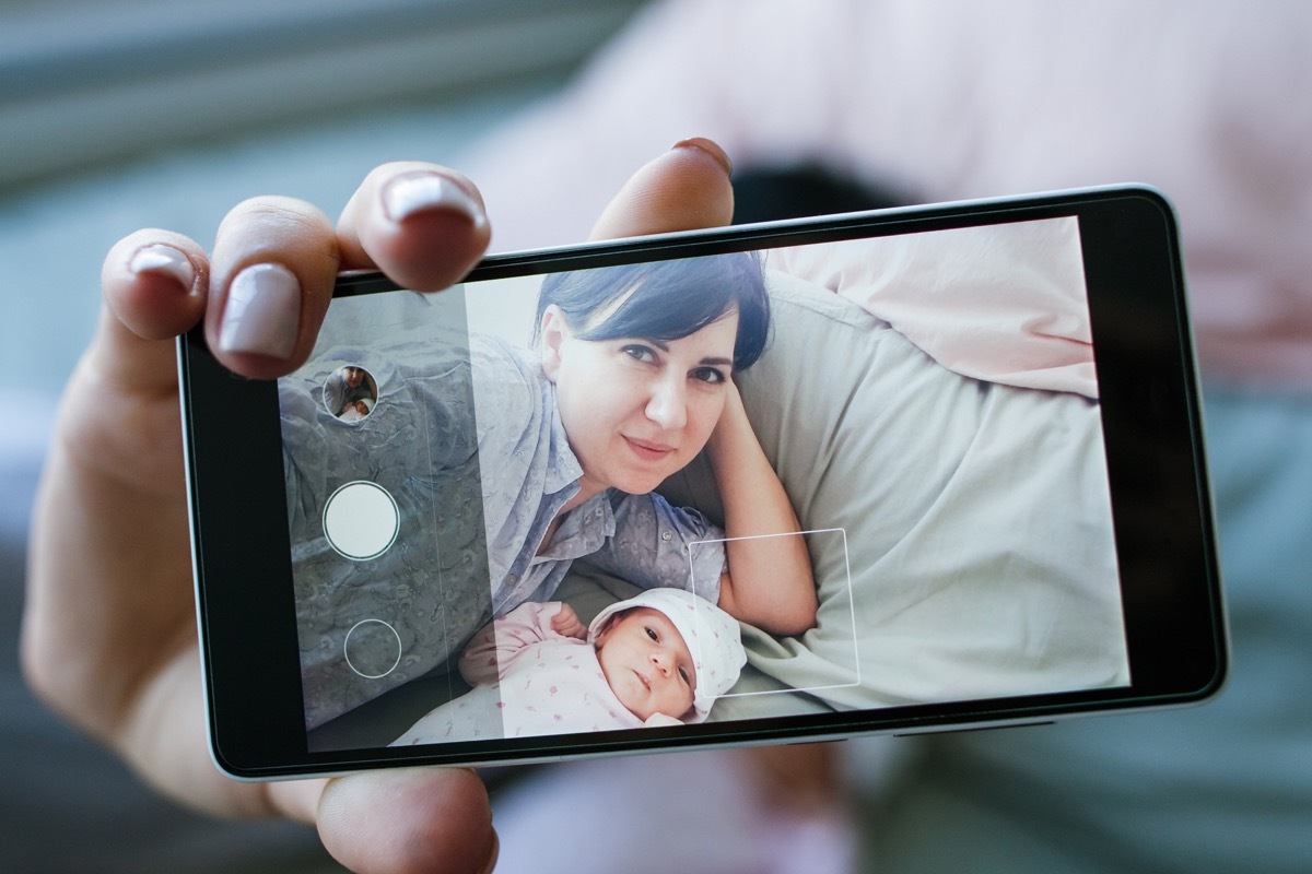 smartphone selfie family newborn mother concept. photo memory. happy motherhood.