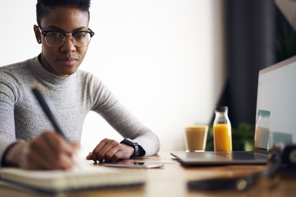 woman writing ways to get a promotion after 40