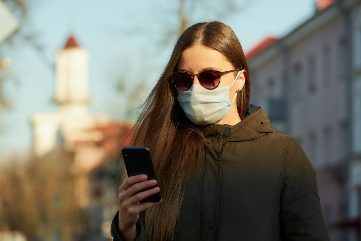 Woman in sunglasses and mask