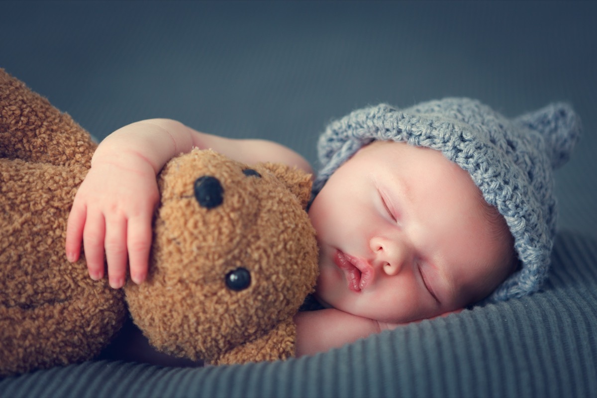 sleeping newborn baby with teddy