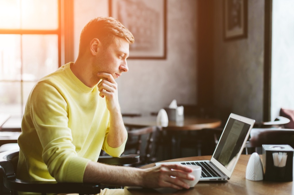 man searching for flight booking cheap flights