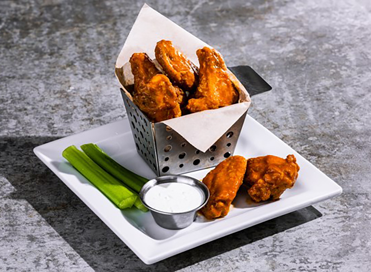 chilis wings plated with ranch and celery