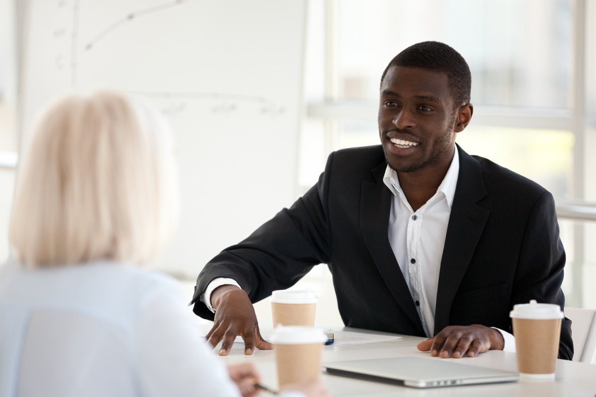 Middle aged Black man talking to older white woman during interview, etiquette over 40