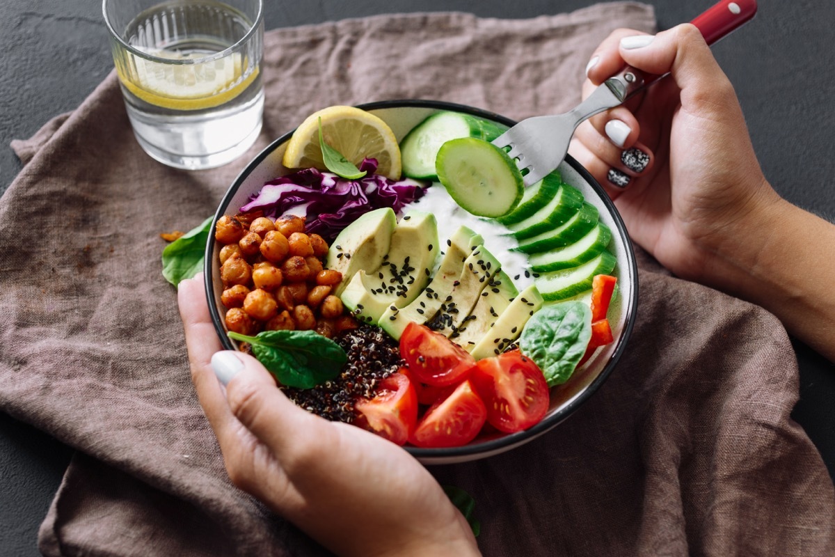 Bowl of colorful salad and a lemon water