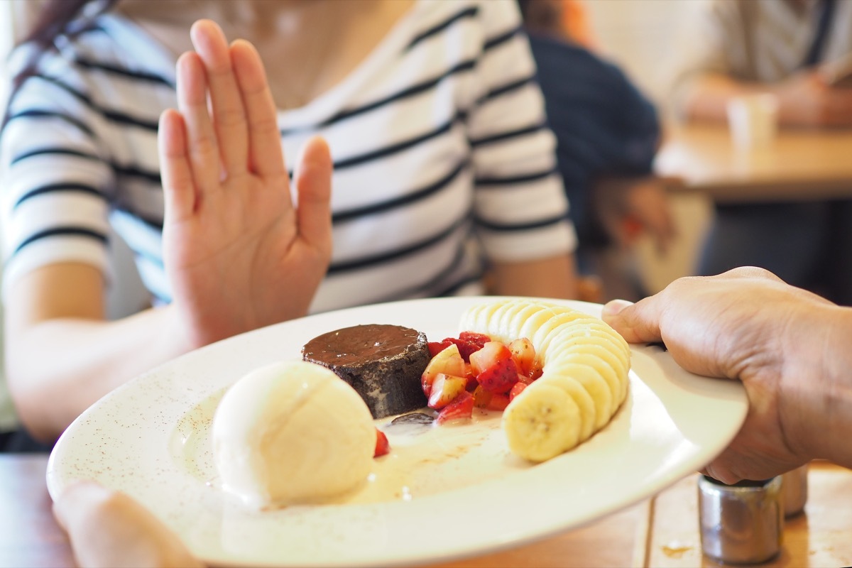 young white woman refusing food